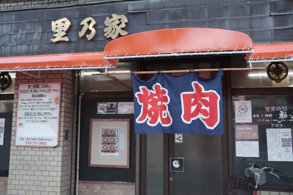 Satonoya’s Kyoto entrance with a red awning and a yakiniku noren